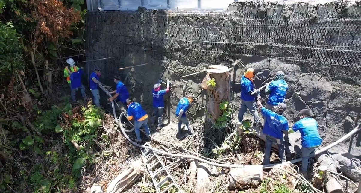 Crew clearing and preparing a steep lava rock hillside