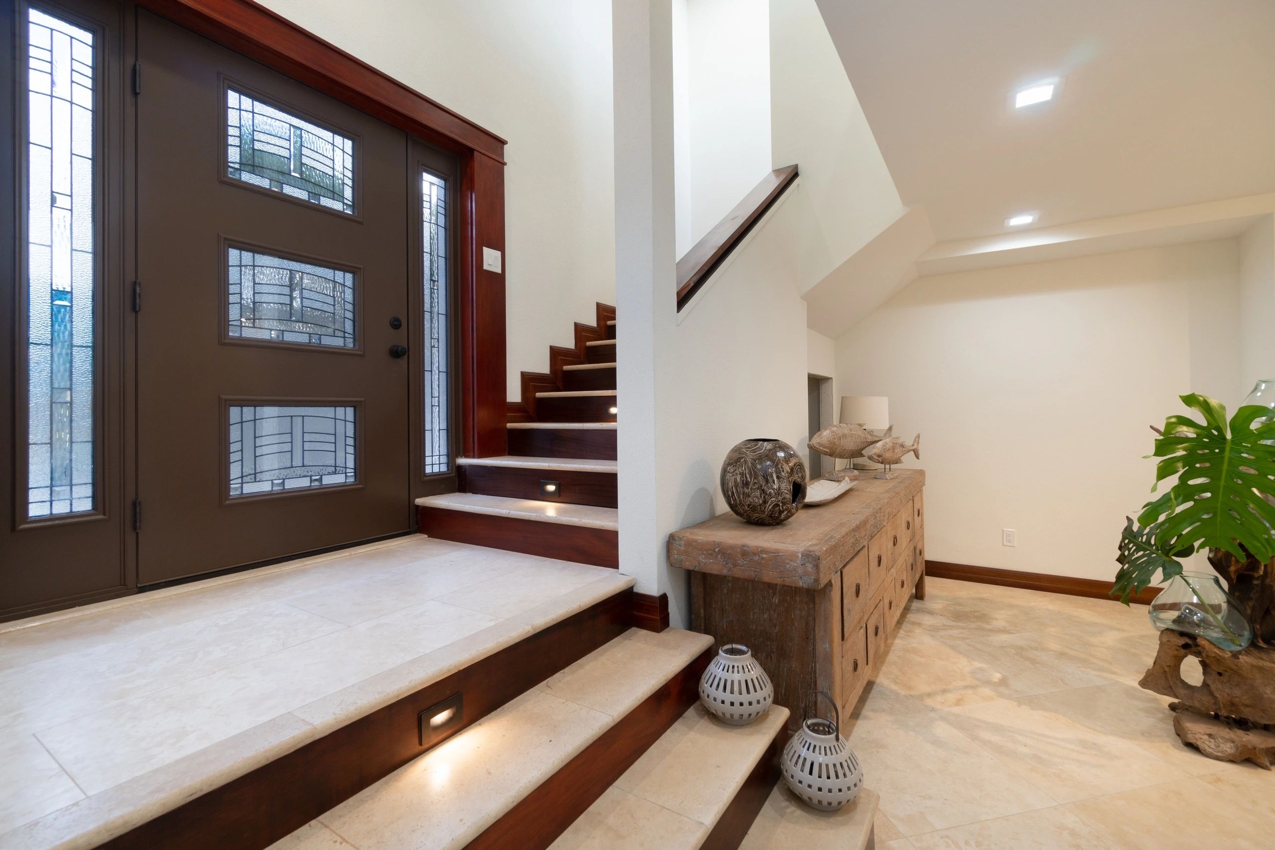 Entry with wood and glass doors, stone steps and recessed stair lights