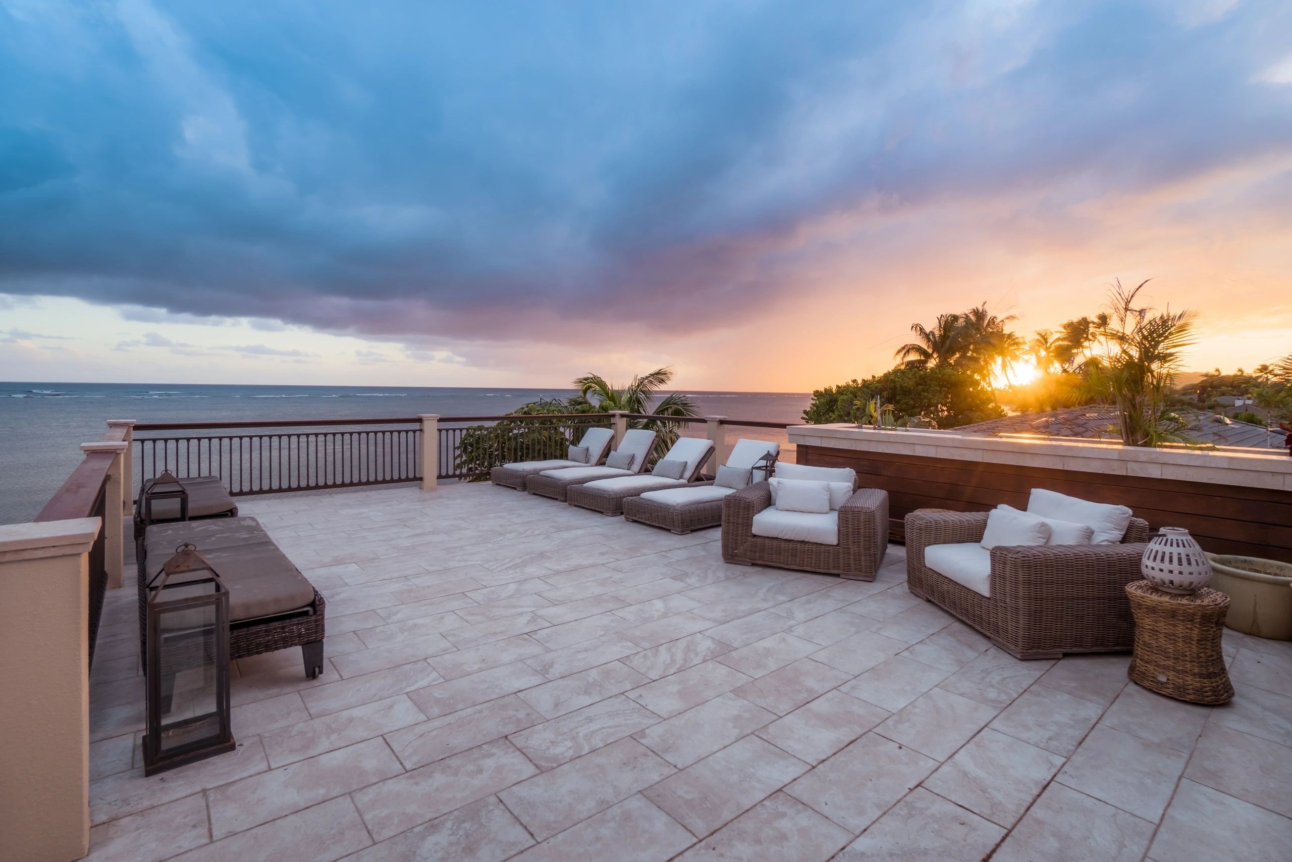 Rooftop terrace with lounge seating at sunset